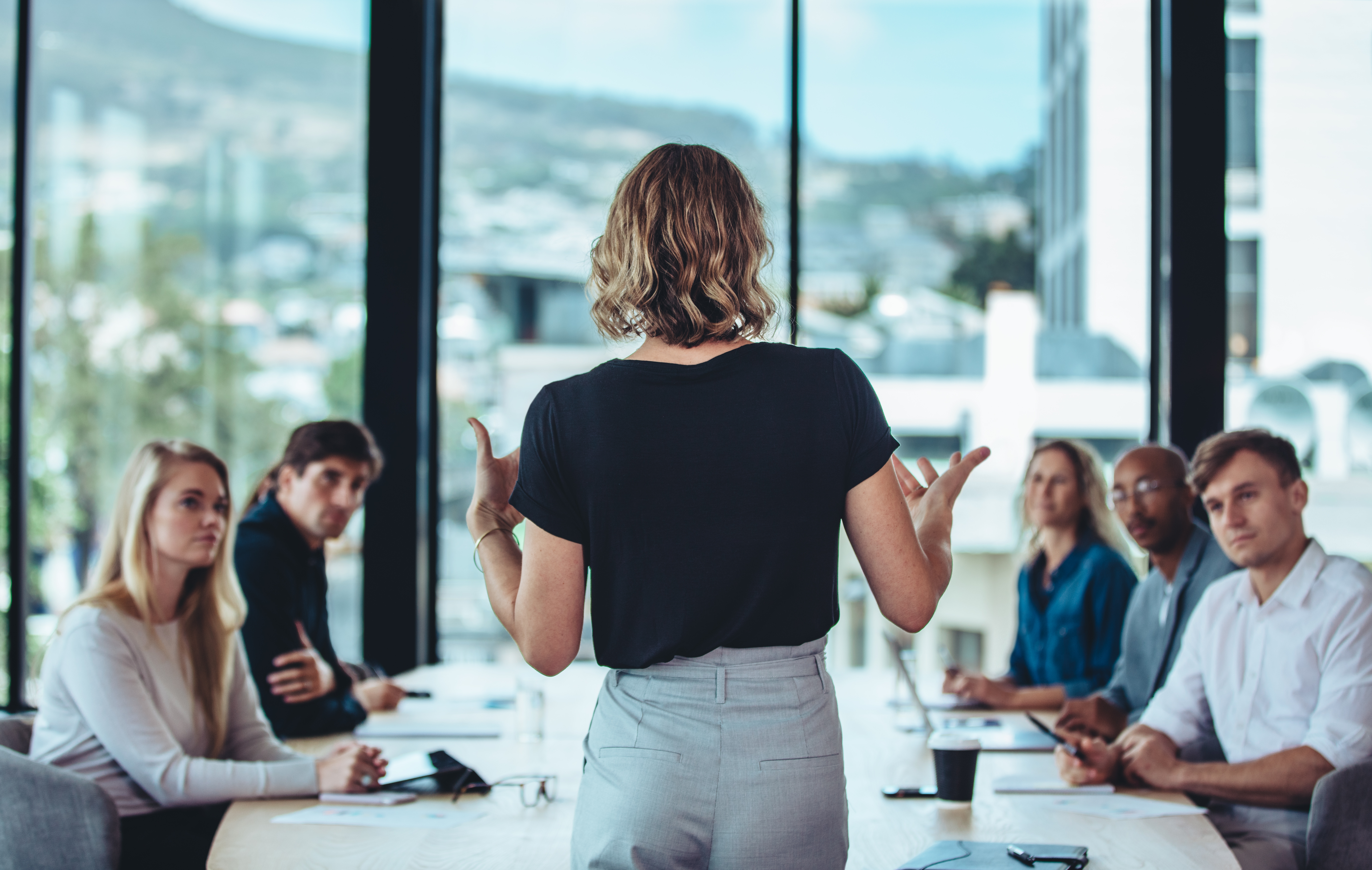 Businesswoman sharing new ideas in meeting | Promote International